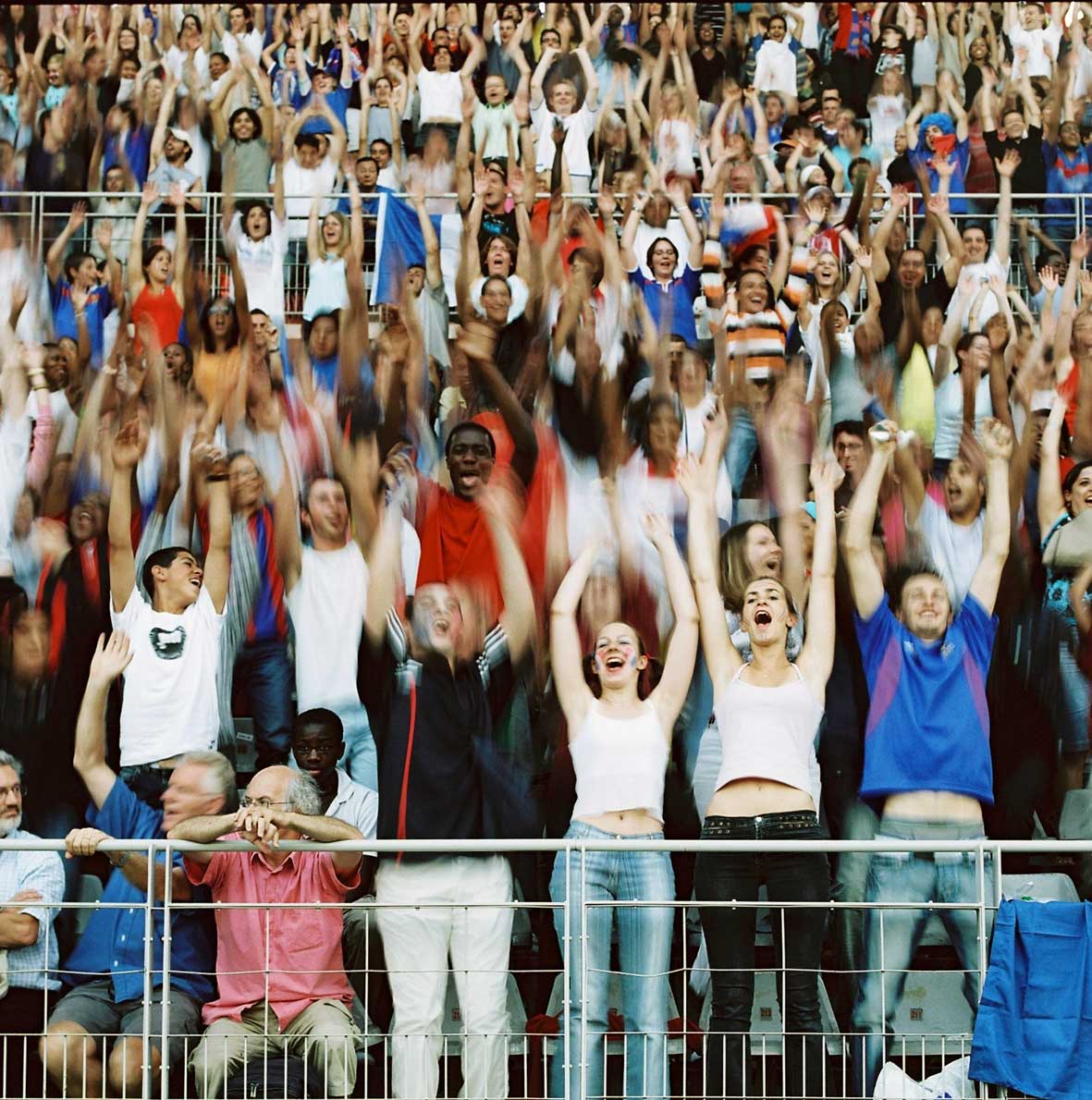 several people are seen cheering while two people perform