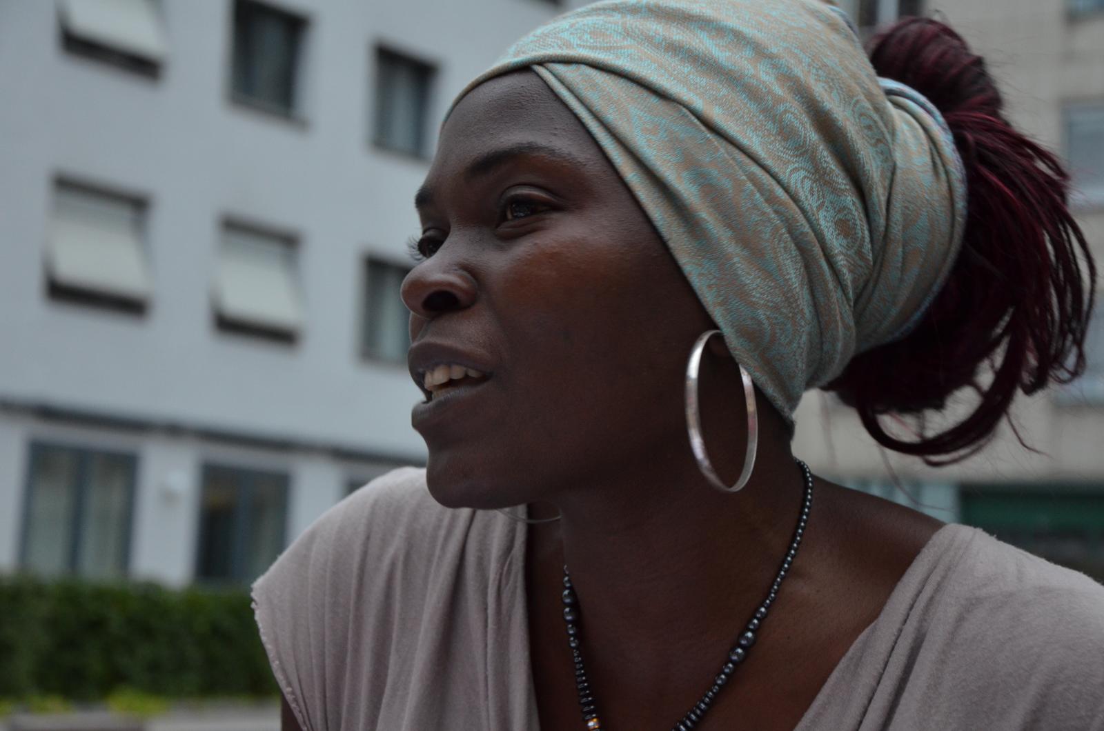 a woman wearing a white t - shirt has ear rings in her ears