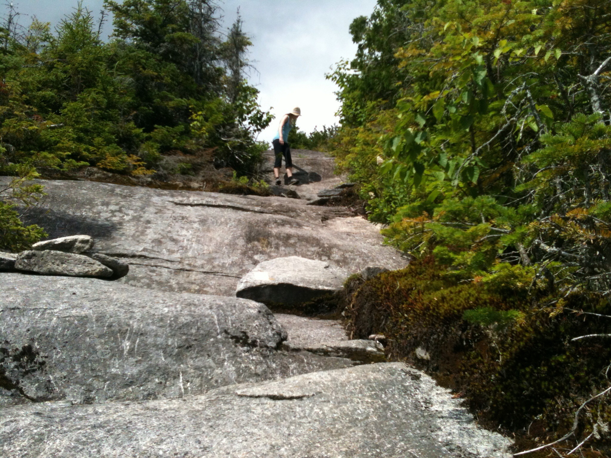the person is walking on the rock path