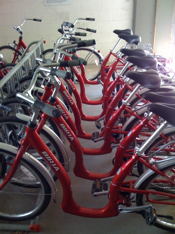 many bikes are arranged on the floor of a building