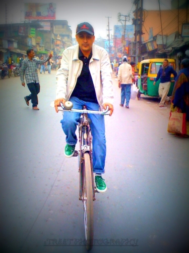 a man is riding on a bike in the street