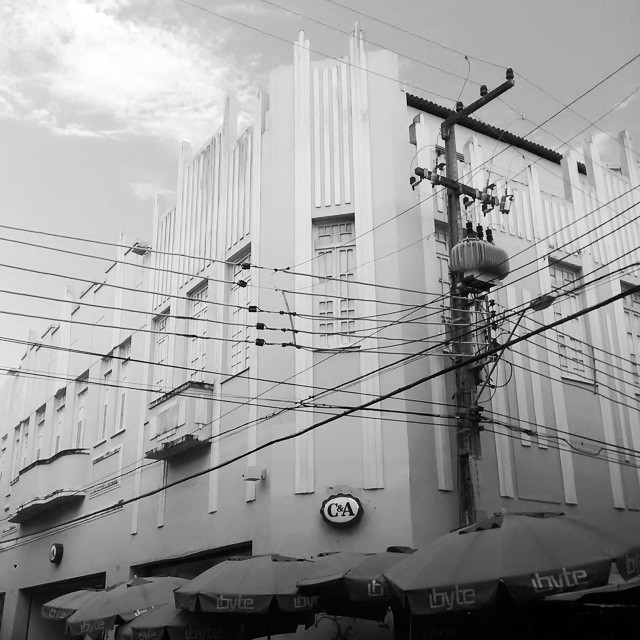a black and white po of a building with many wires