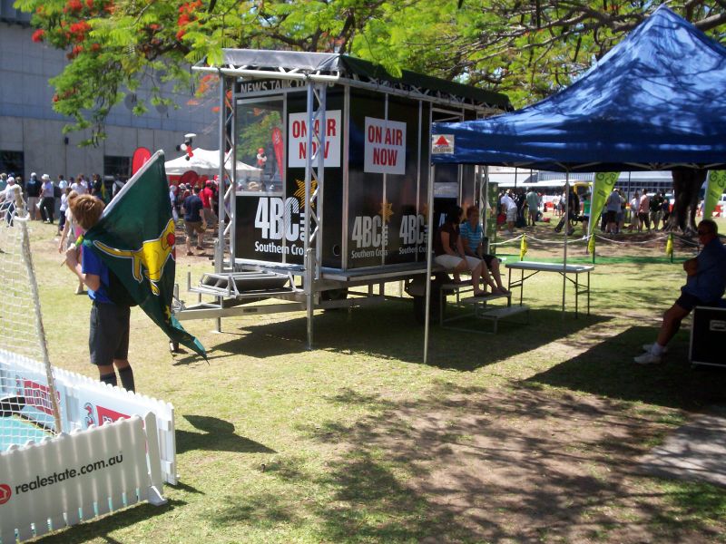 an open air fair with people seated around tables