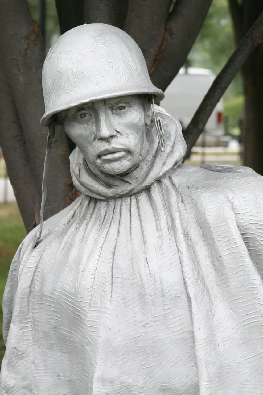 a close up of the head and shoulders of a statue of a man