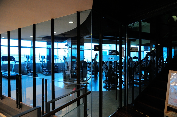gym with mirror wall showing gym equipment