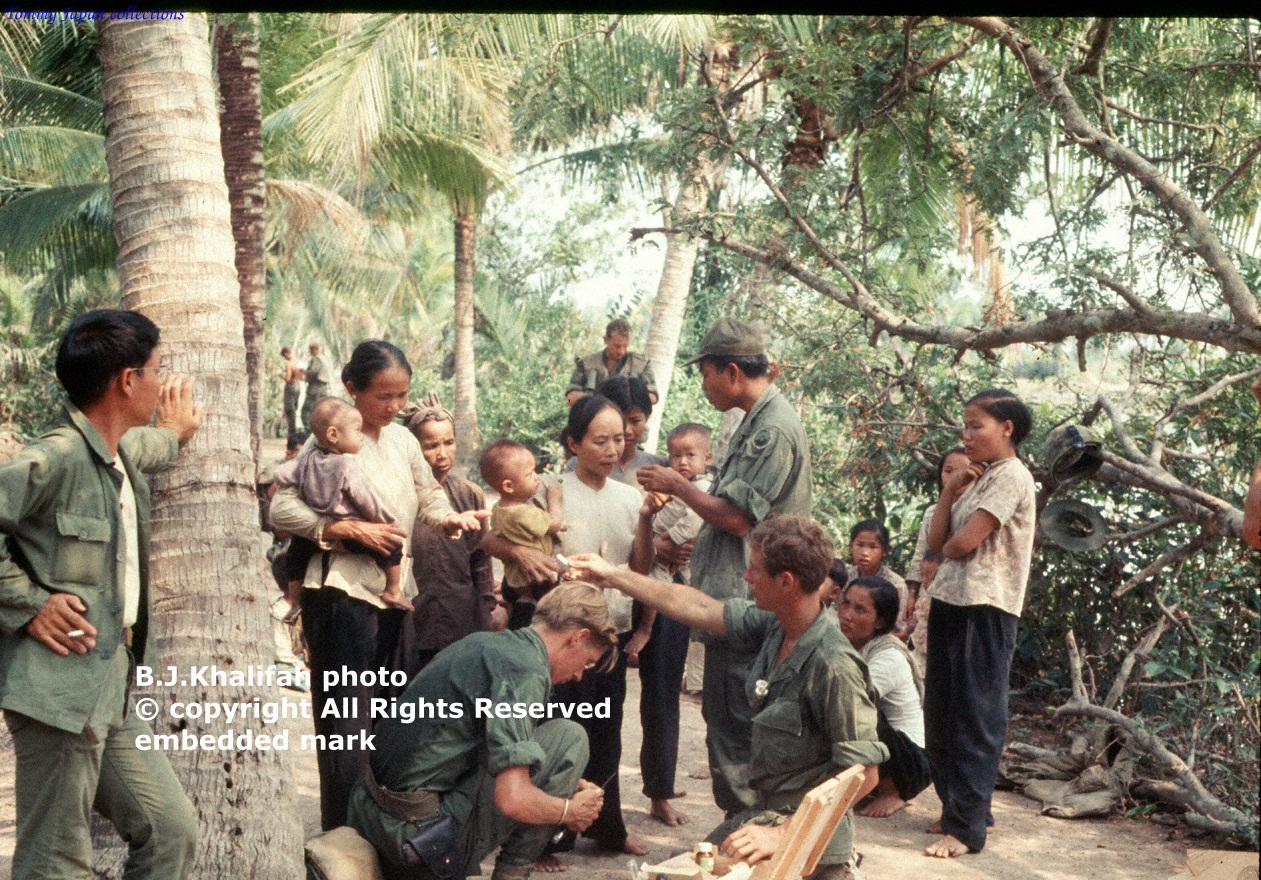 a group of people are on the ground with a man kneeling