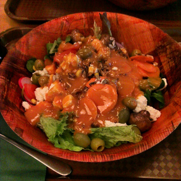 a vegetable dish served in a bowl with dressing