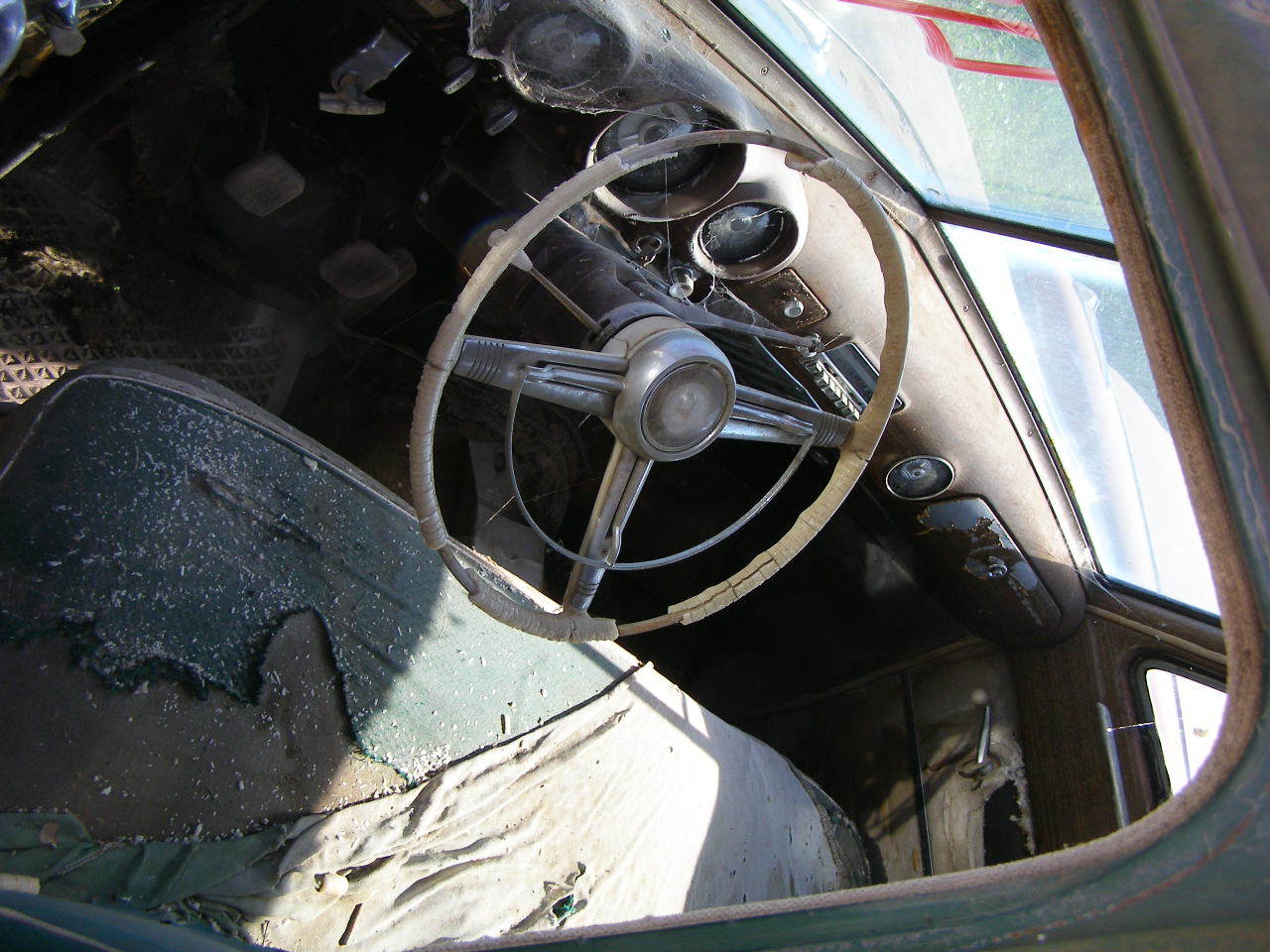 a vehicle dashboard with the steering wheel still intact