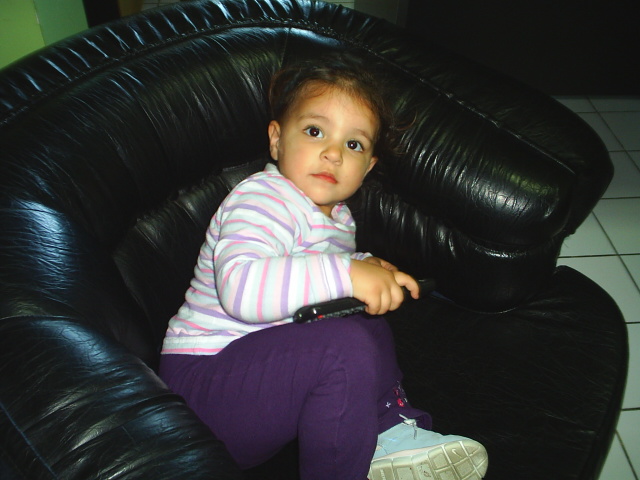 a small child sitting on top of a couch