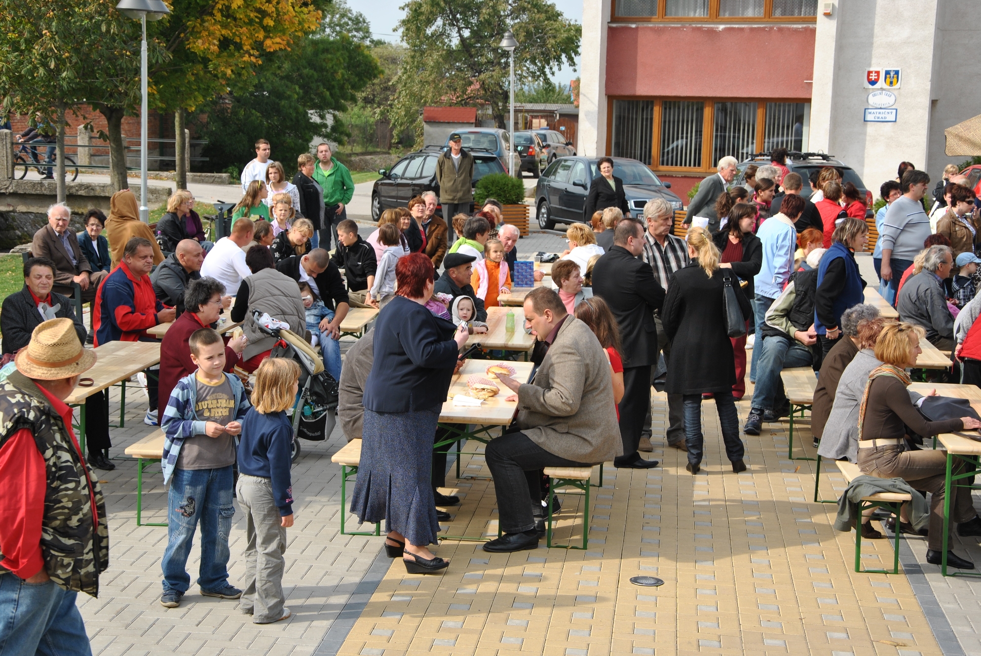 a group of people sitting around tables with umbrellas