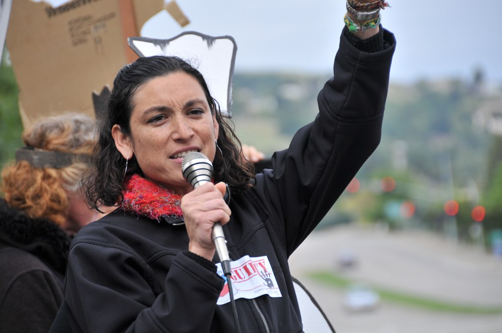woman holding a microphone up to the sky and gesturing