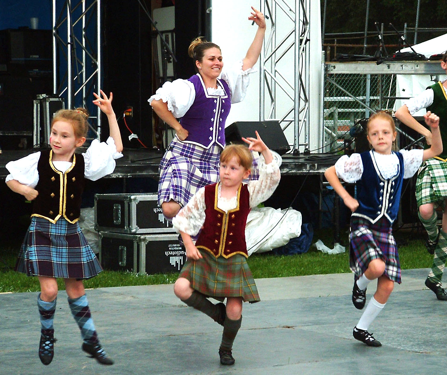 a group of children in scottish outfits playing a musical