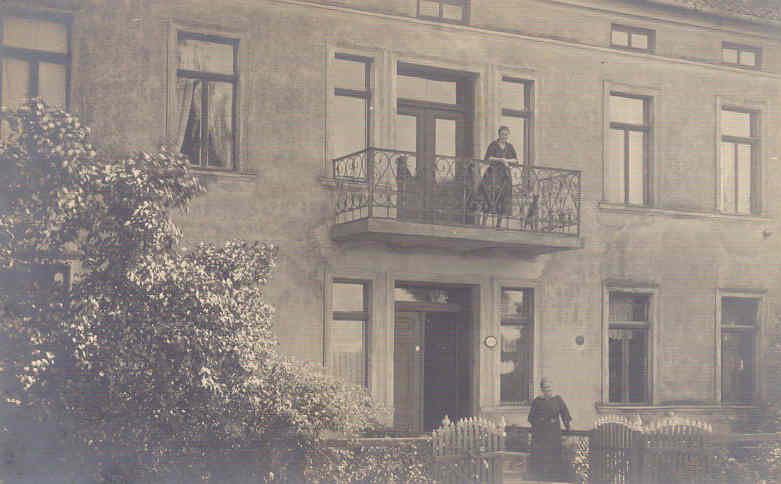 two people on the balcony of an old building