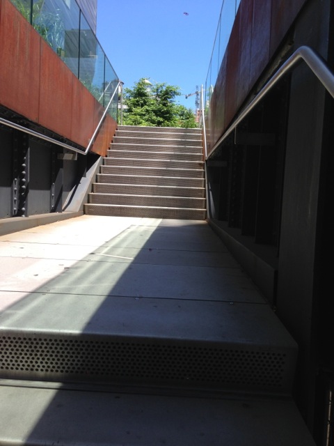 an escalator with steps leading up to an entrance