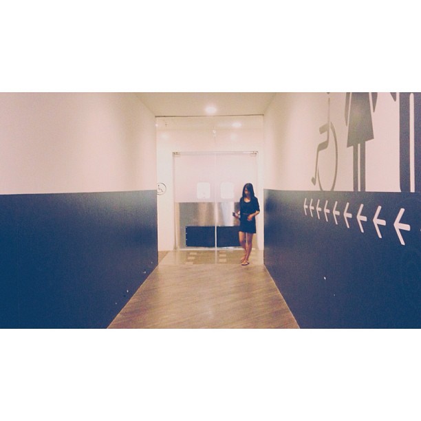 a woman stands at the entrance to a white and blue room