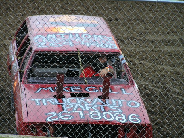 a man in a race car painted with writing