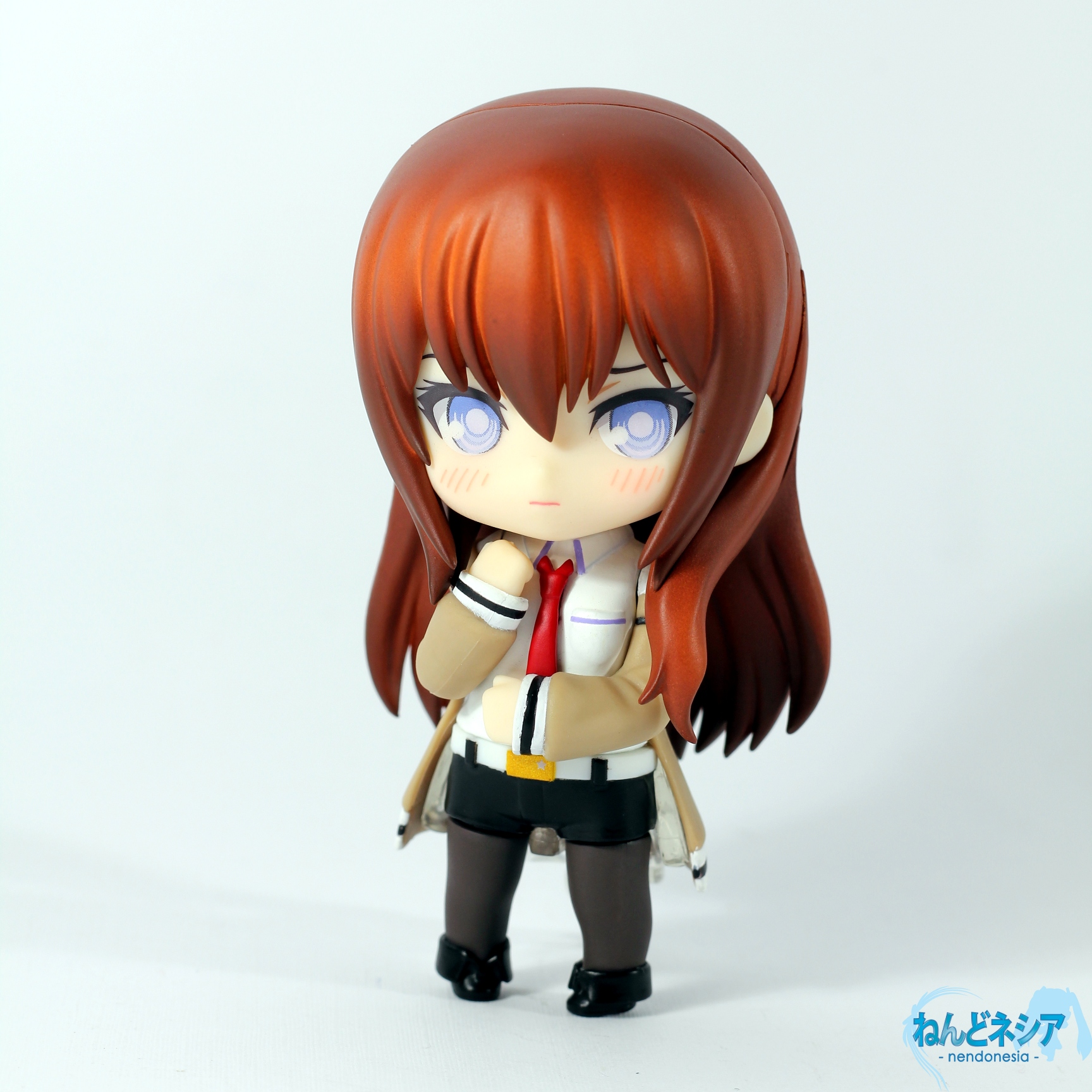 an anime toy is posed on a white surface