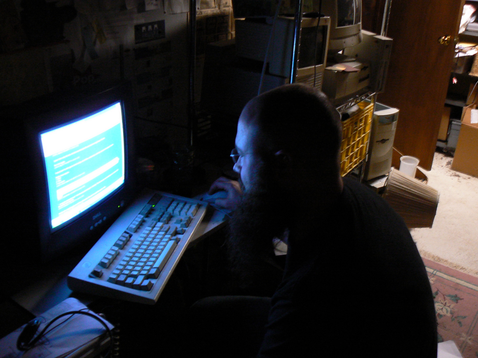 a man using a keyboard and mouse in front of a computer screen