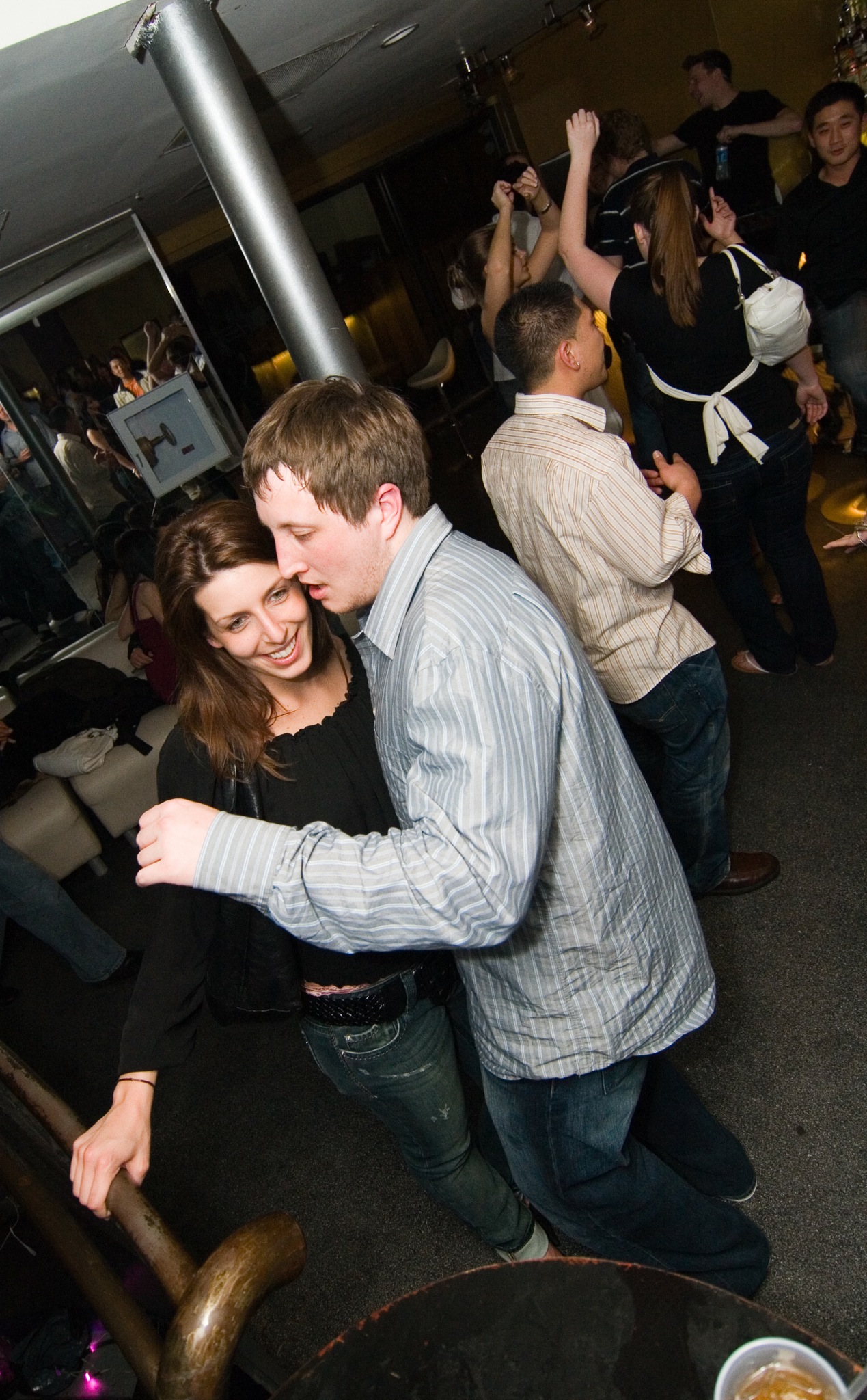 a couple of people dancing in front of a group of people