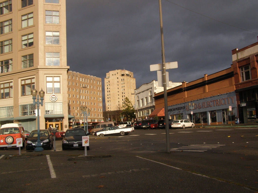 an empty street in front of tall buildings