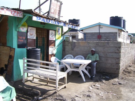 a small shack with several tables outside of it