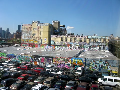parking lot with a large wall full of graffiti