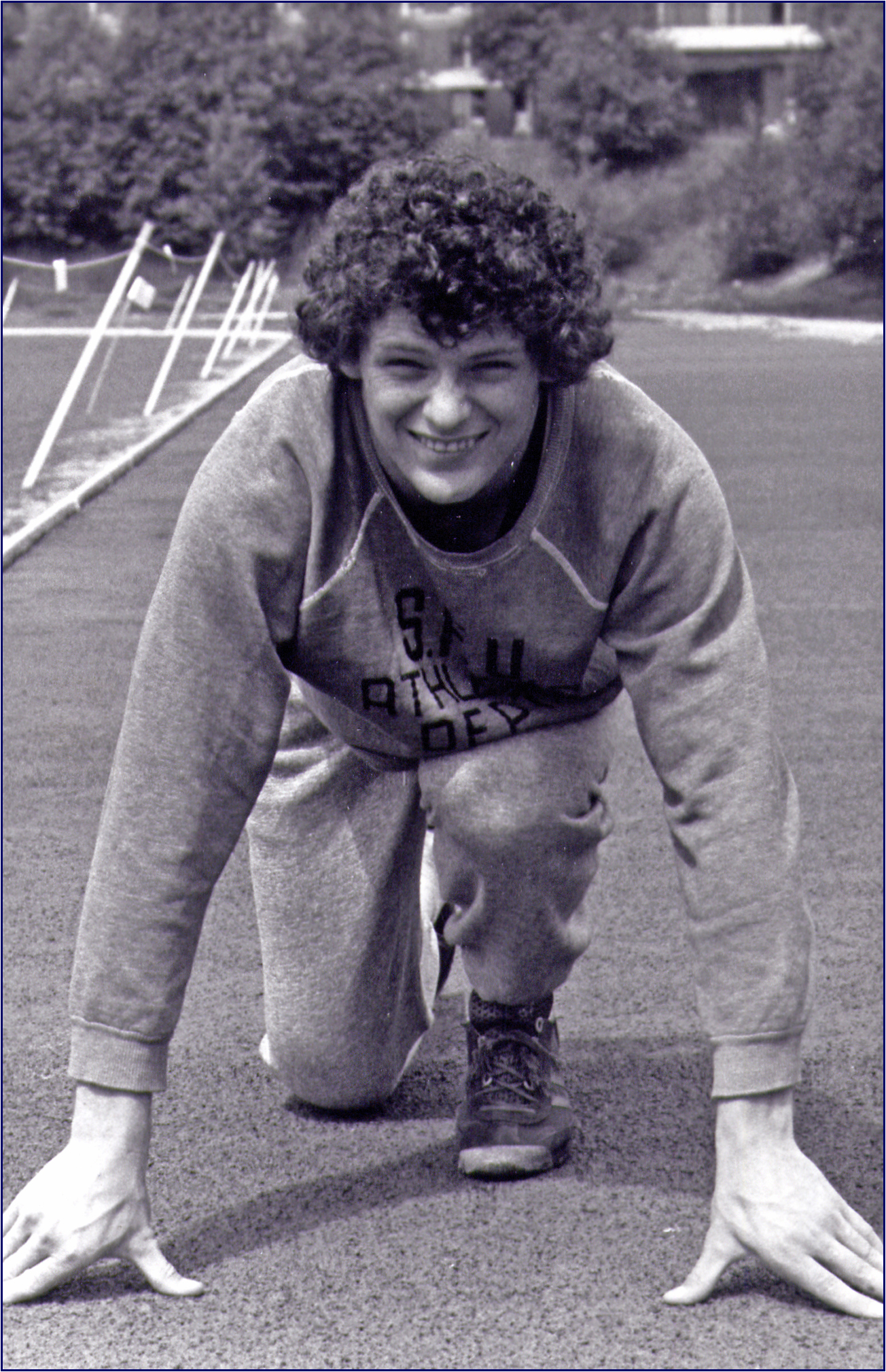 a little girl on a soccer field smiles