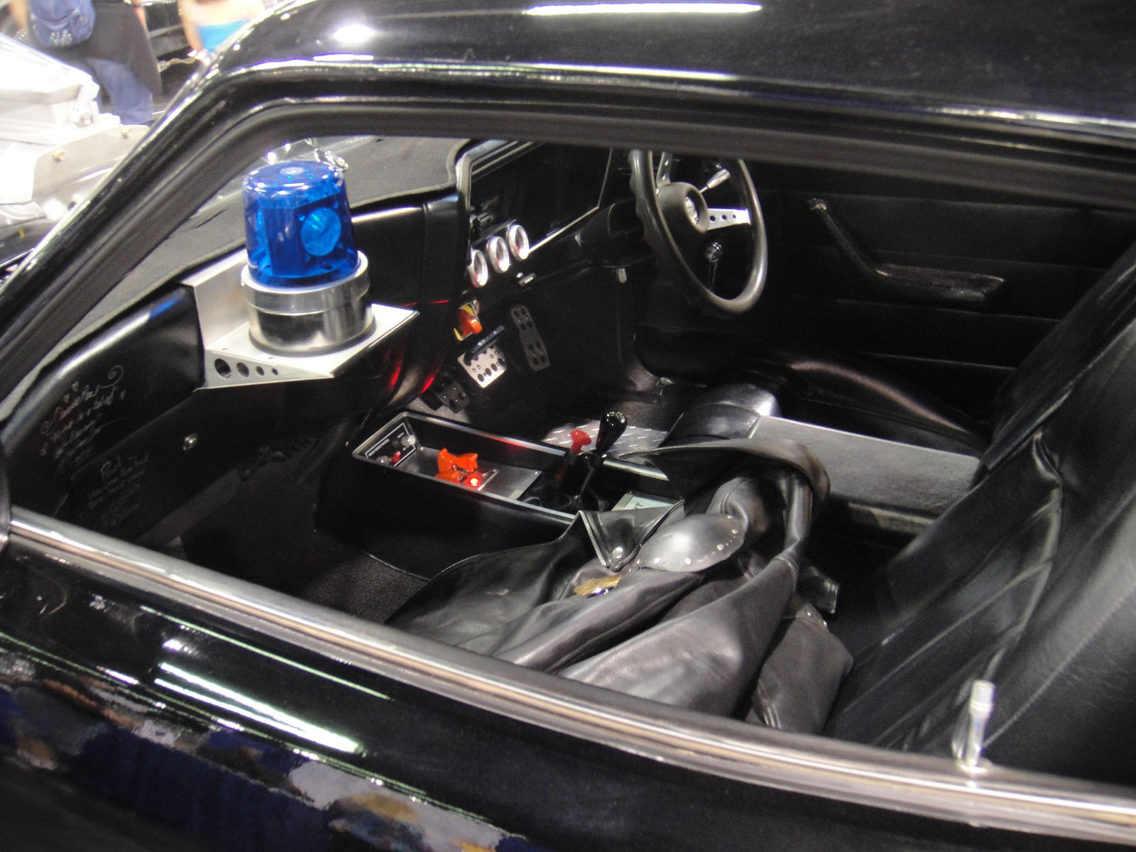 an old black car with leather interior and dashboard