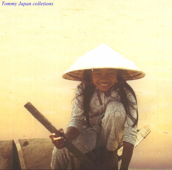 a woman wearing a vietnamese hat is smiling