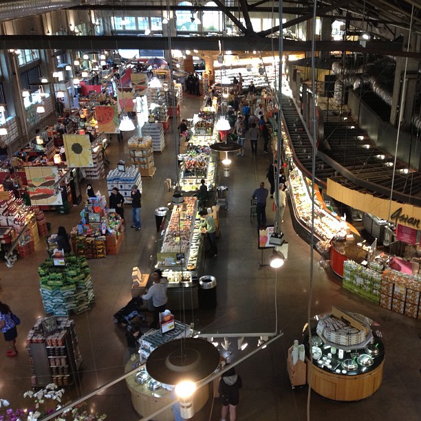 people are shopping in an indoor store filled with items