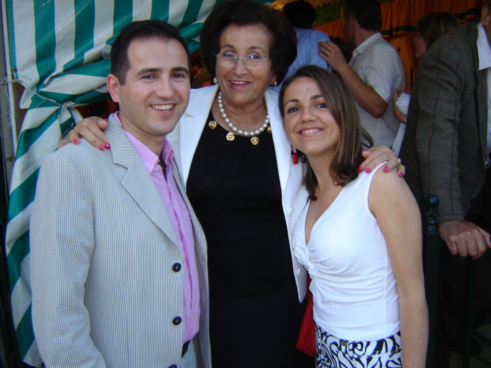 two women and an older man posing together