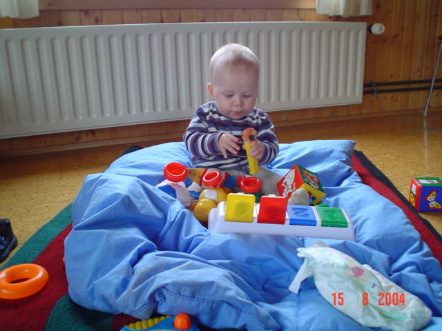 a baby is playing with some toys on a bed