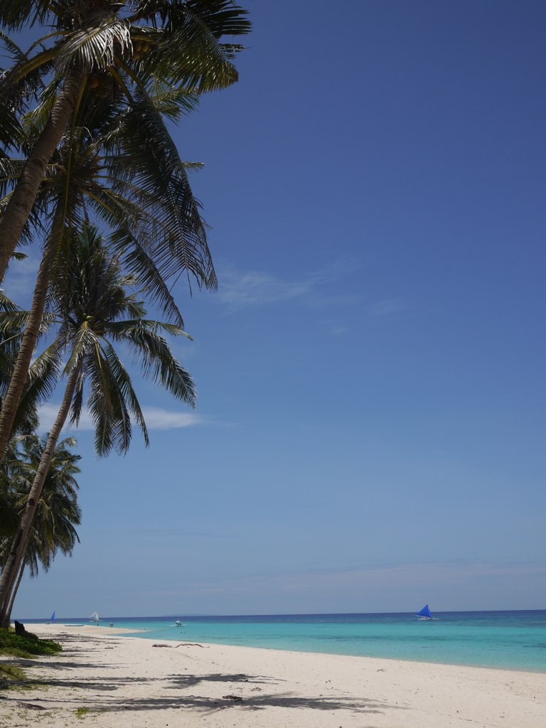 the ocean is crystal blue and clear during the day