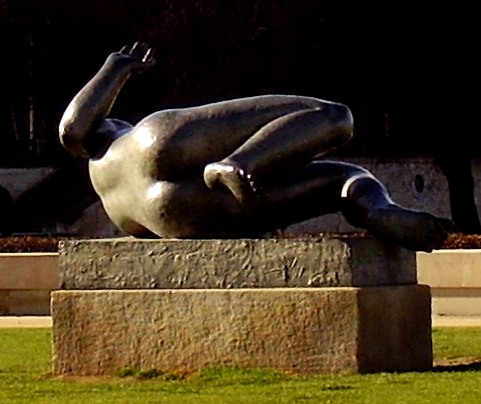 a statue of a man laying on his back