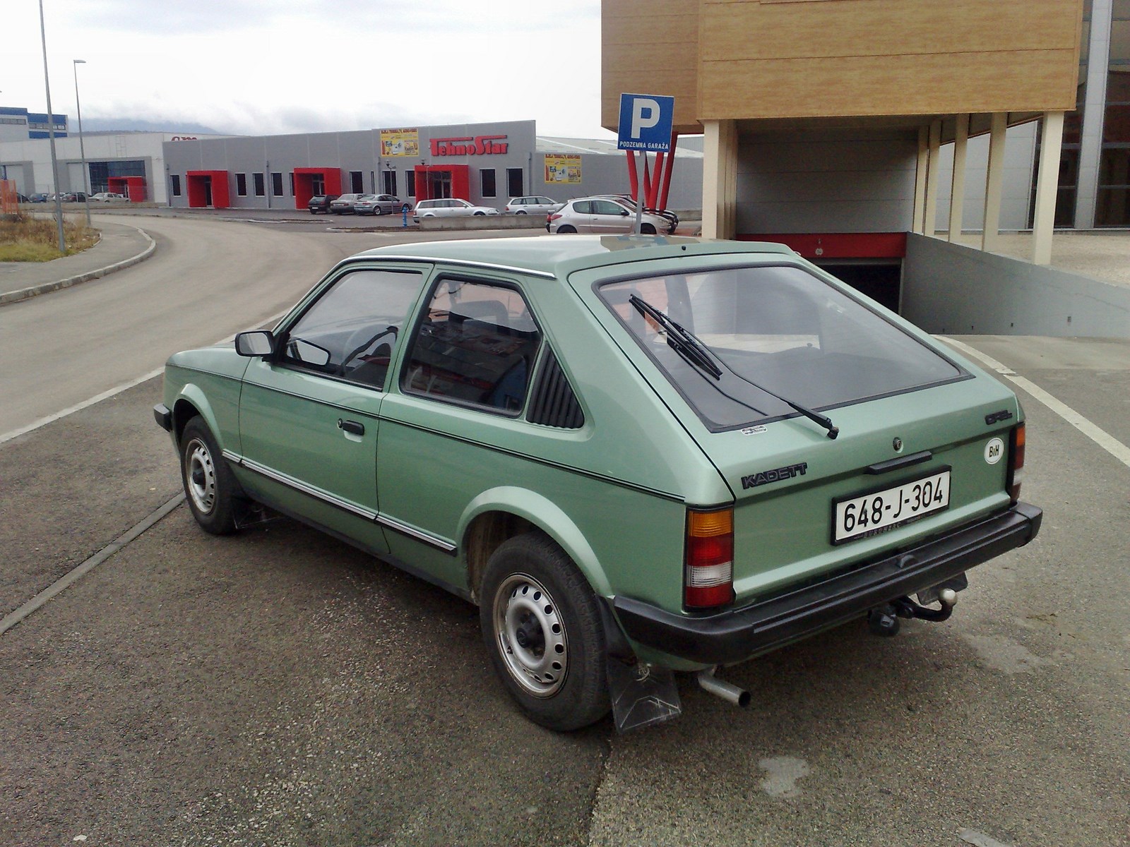 an old car in a lot with no cars parked