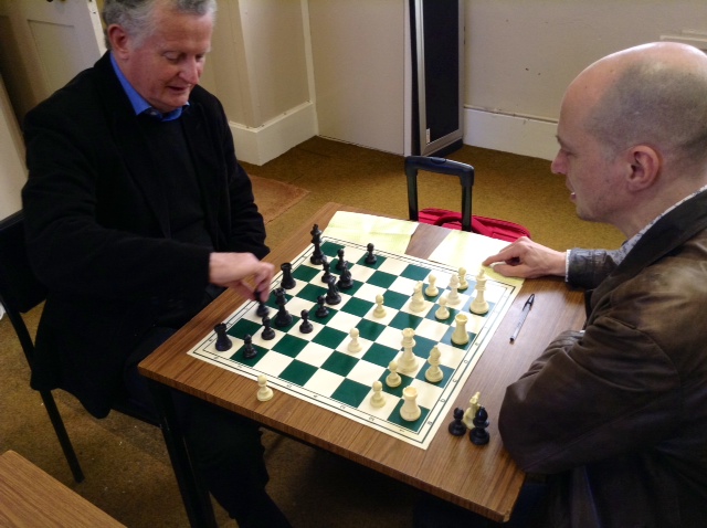 a couple of men play a game of chess