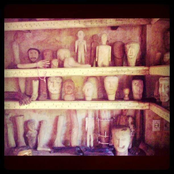 many different heads of men in display on shelves