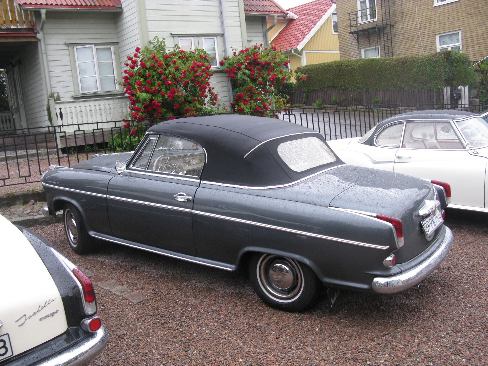 black car parked near other cars near some houses