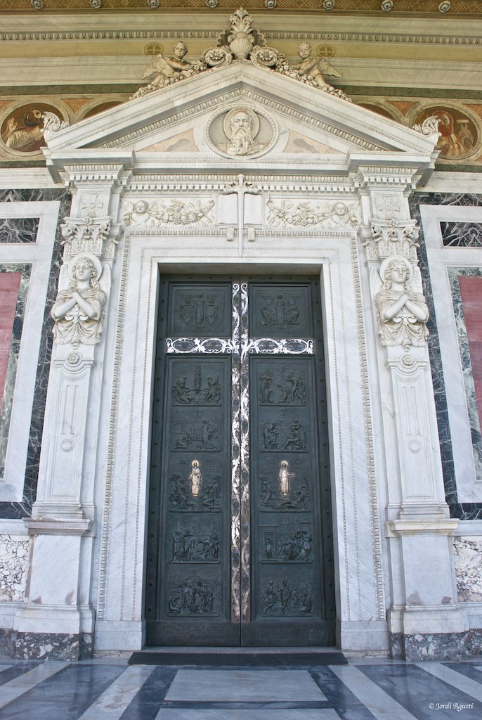 a big doorway that has a cross on the door