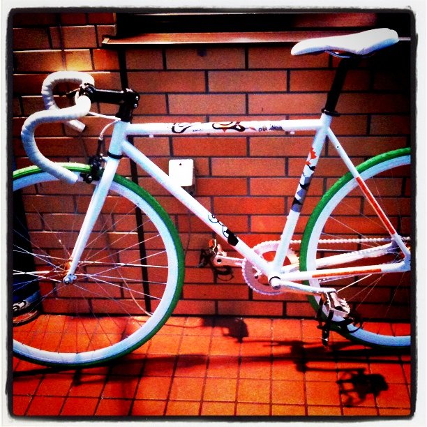 a bike parked against a brick wall