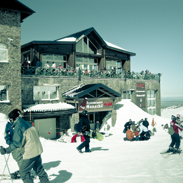 people skiing outside a resort building during the day