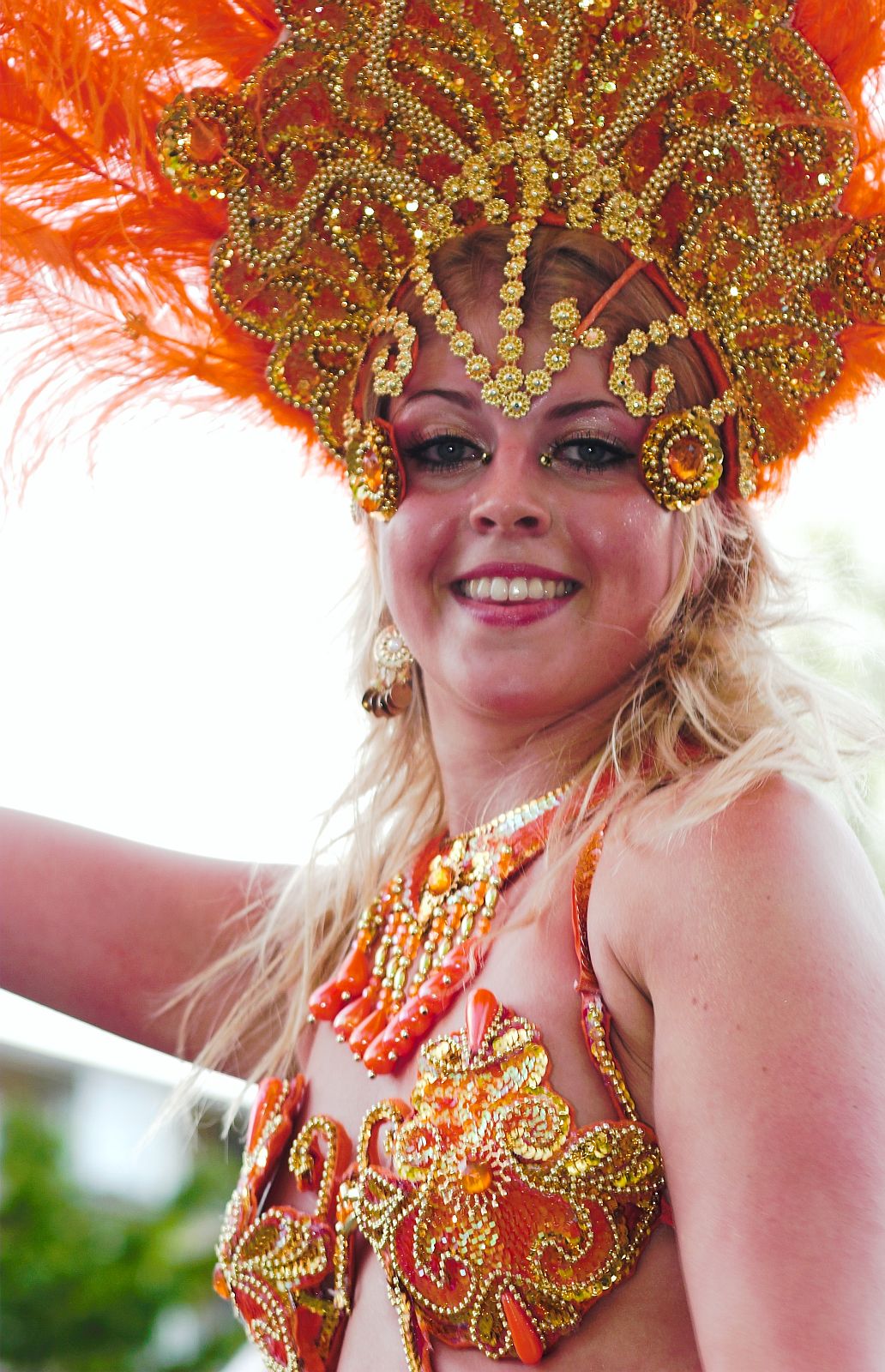 a woman wearing an elaborate gold headdress and beads