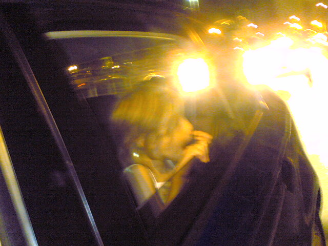 a woman talking on her phone while in a car