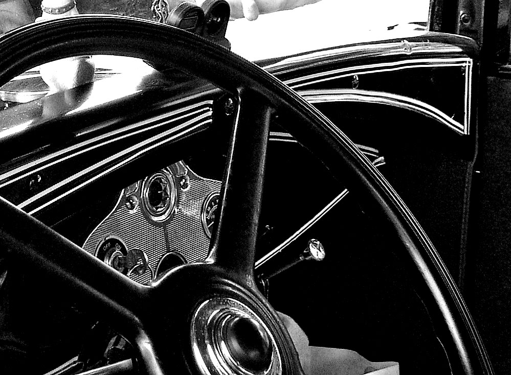 the dashboard and dashboard wheel of an old car