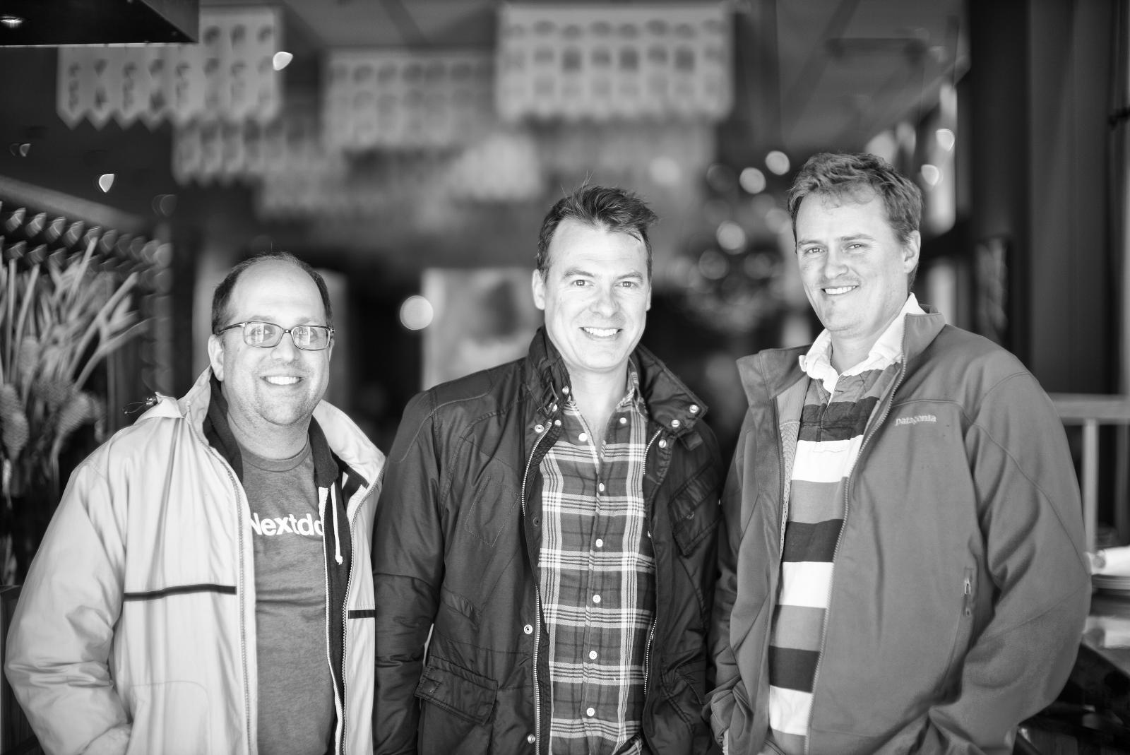 three men posing for the camera at a el