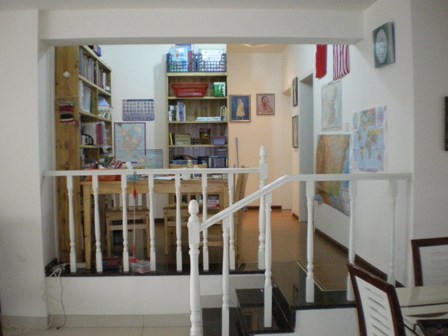 white railing on the first floor and bookcase with books