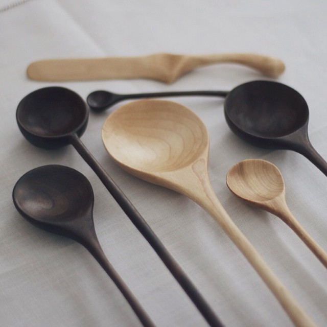 several spoons and bowls lined up in a row