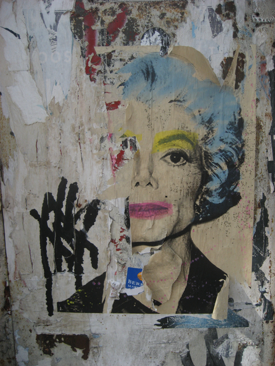 a graffiti painting on a wall with blue hair and yellow hair