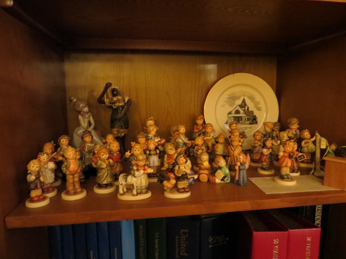 the bookcase has some figurines on it