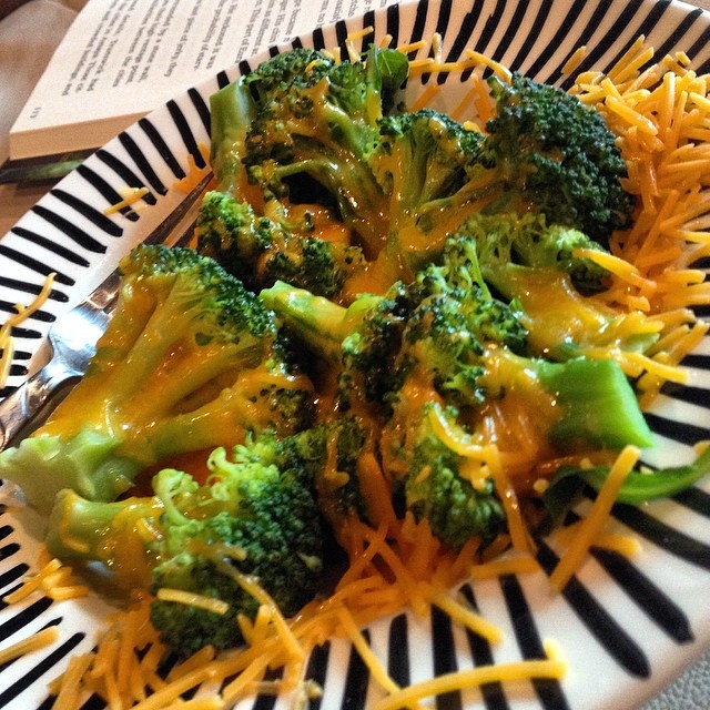 broccoli and cheese with shredded cheese in a bowl